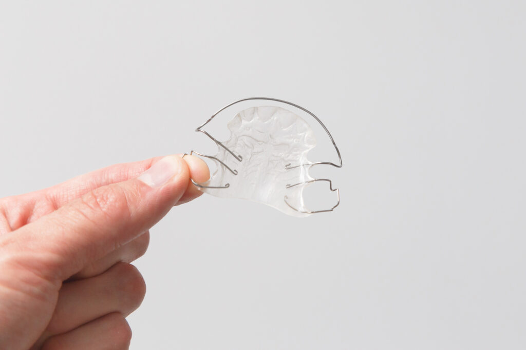 Orthodontic removable plate in hand.